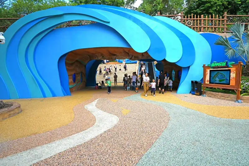Multi-colored resin bound surface with flowing design at a theme park entrance